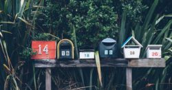 Six colorful mailboxes in a row