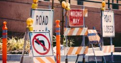 assorted-color signage lot on road during daytime