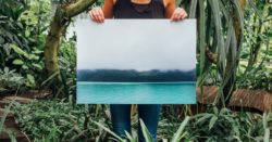 woman holding photo of tidal wave