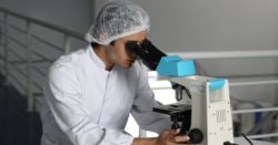 Man looking into microscope