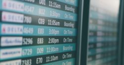 Airport departures timetable showing Delta and Alaska Airlines flights on time and boarding