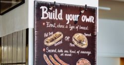 A "build your own hot dog" blackboard in a cafe