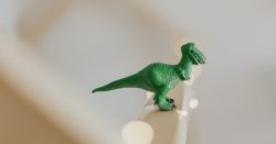 Small green figurine of a toy t-rex