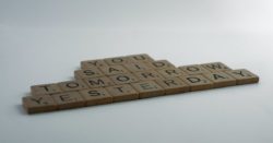 Letters from Scrabble game arranged to spell "You said tomorrow yesterday"